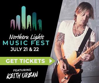 Keith Urban playing guitar with the Northern Lights Music Fest logo.