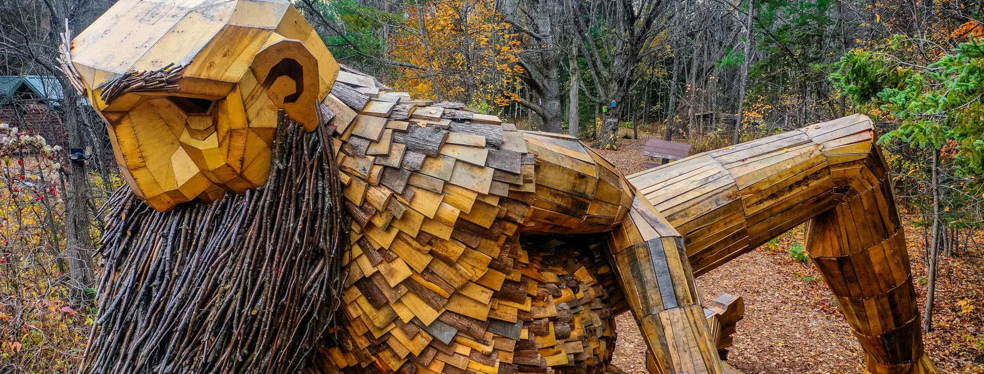 Sculpture of Benny the Beard Fisher, a troll created by artist Thomas Dambo, displayed in Germfask, Michigan