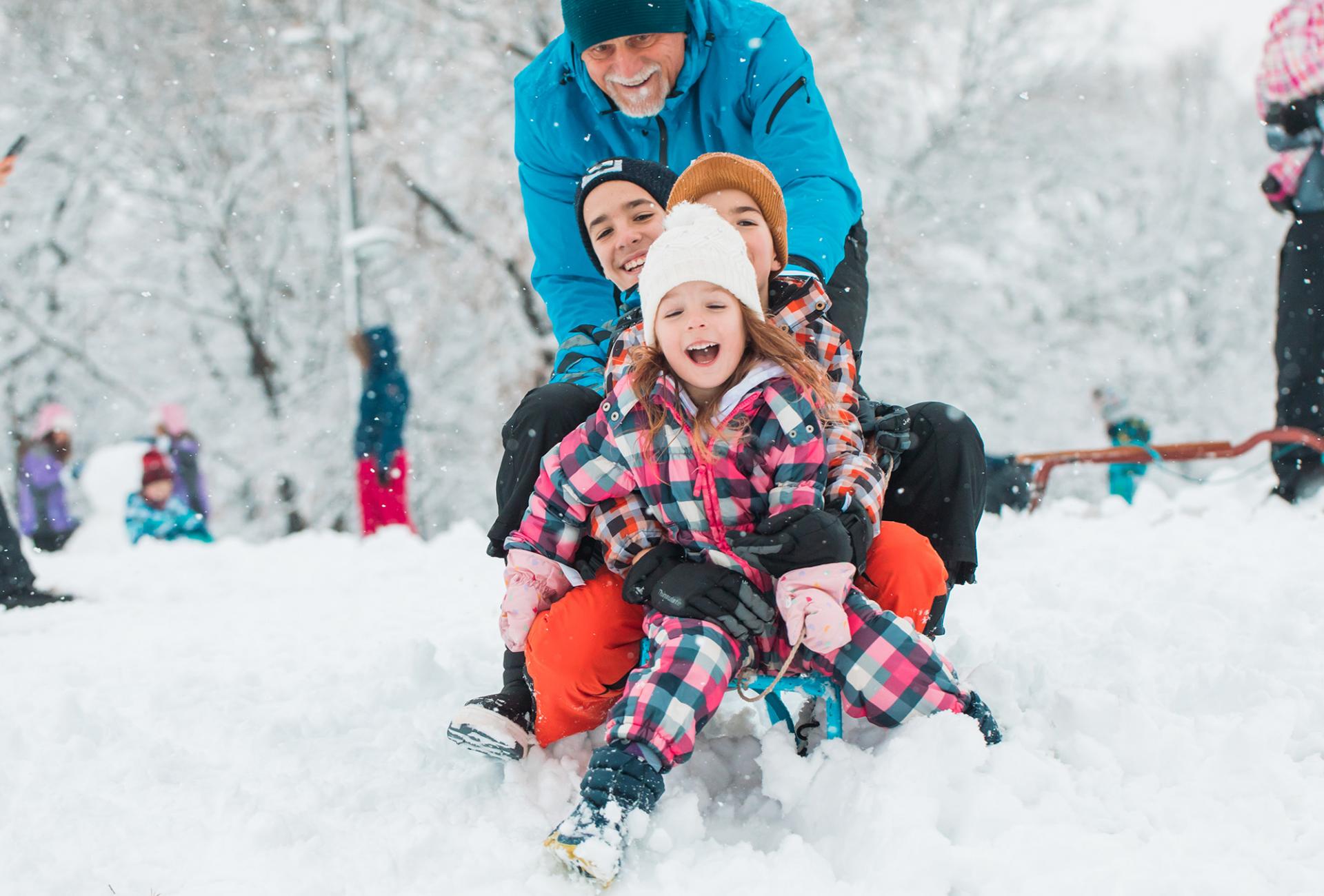 family sledding in winter