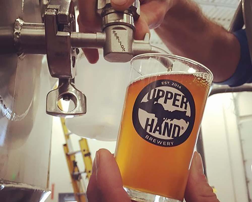 A beer being poured at a brewery.