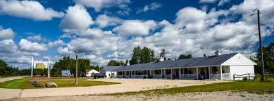 this photo showcases the charming exterior, set amidst lush greenery. The Inn