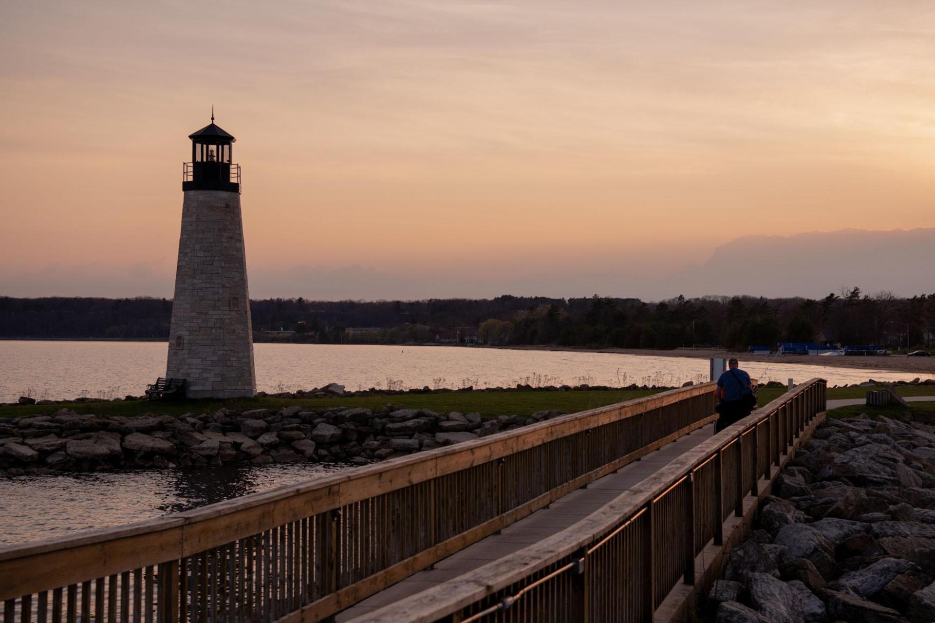 Wheelchair accessible wooden walkway leading to a lighthouse.