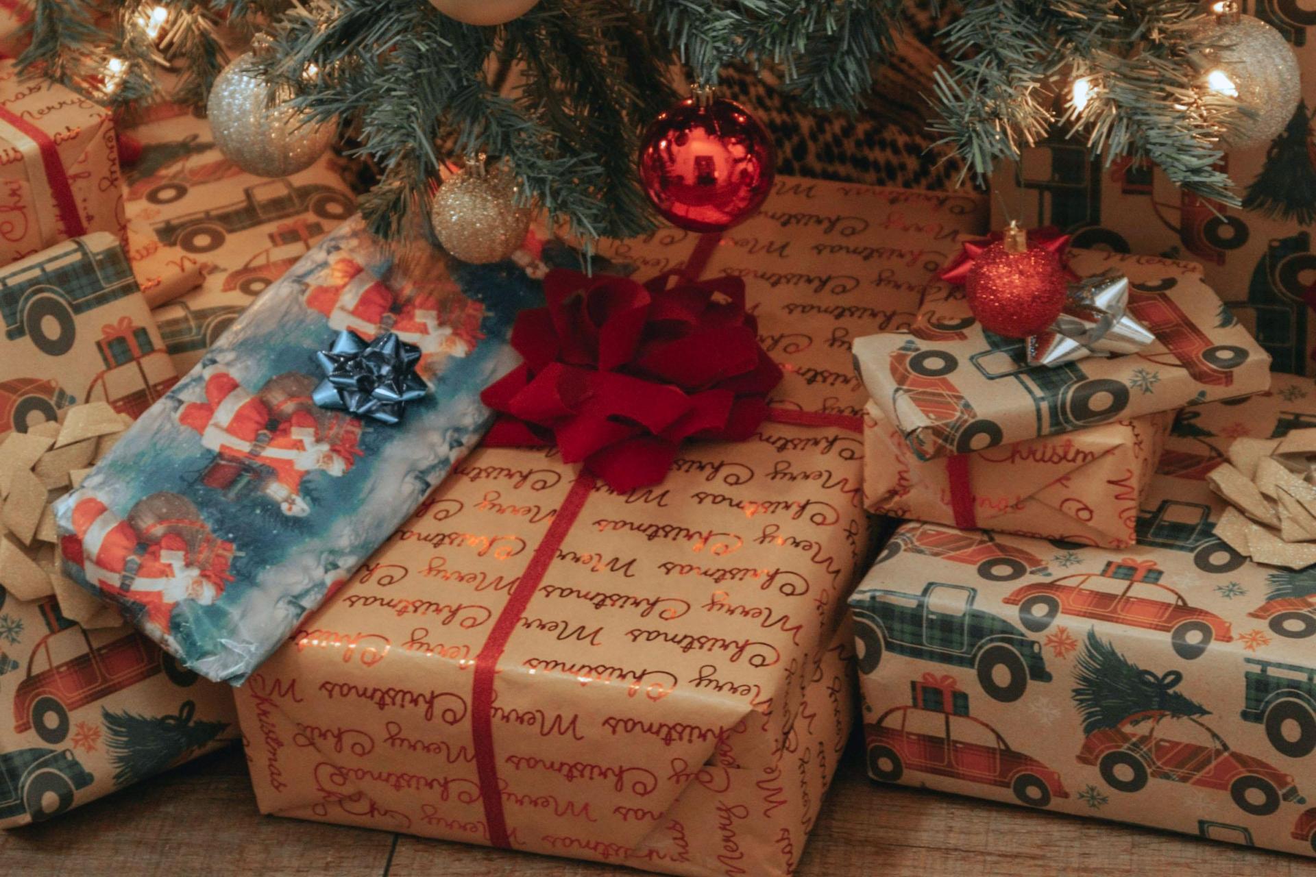 Wrapped Christmas gifts under a decorated tree.