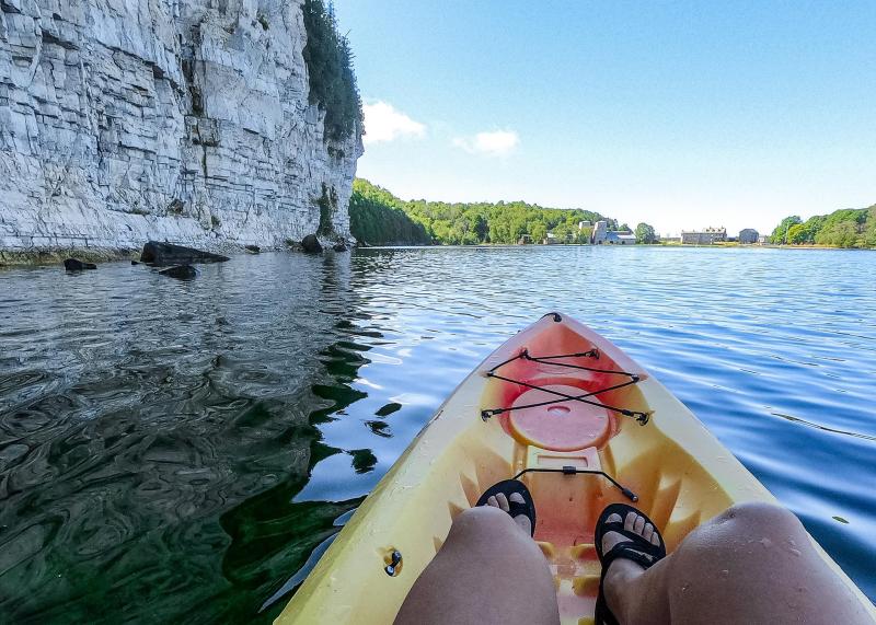 A kayaker paddles near the cliffs at Fayette Historic State Park.