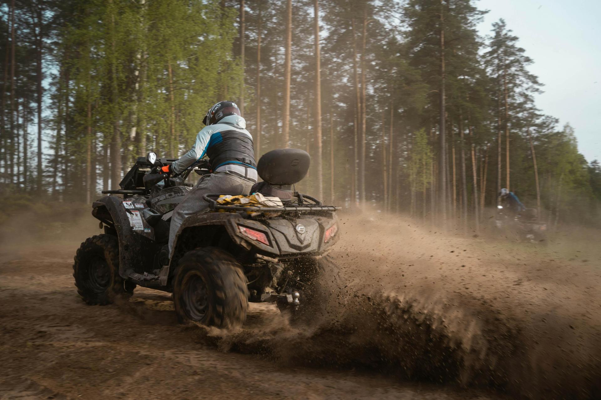 Four-wheelers kick up dirt along the trail.