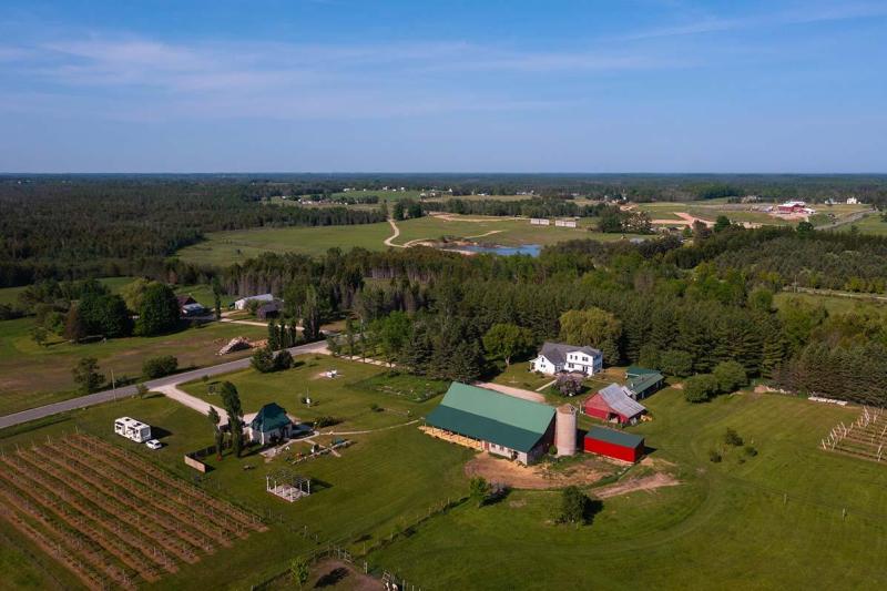 An aerial view of Northern Sun Winery surrounded by fall colors.
