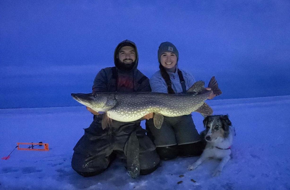 Couple ice fishing Bays De Noc