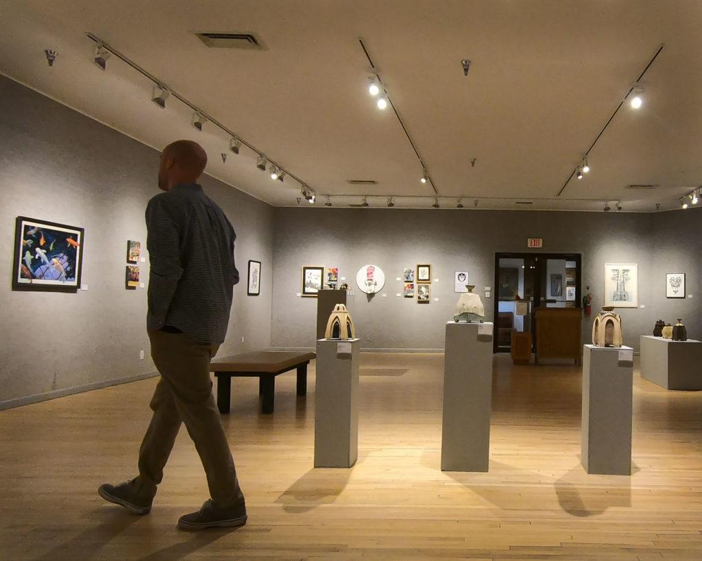 man standing in an art museum