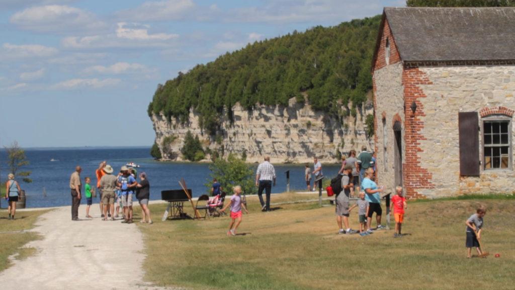 crowd of people walking around outside fayette historic townsite