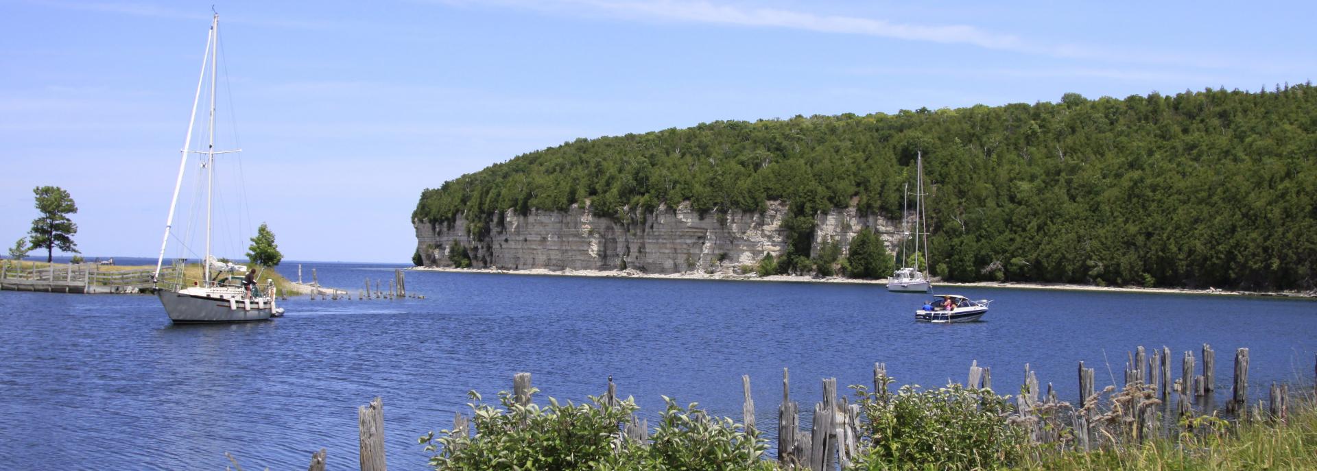 landscape view of fayette bluff and sailboat on the water