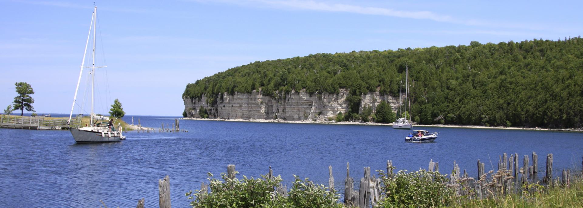 landscape view of fayette bluff and sailboat on the water