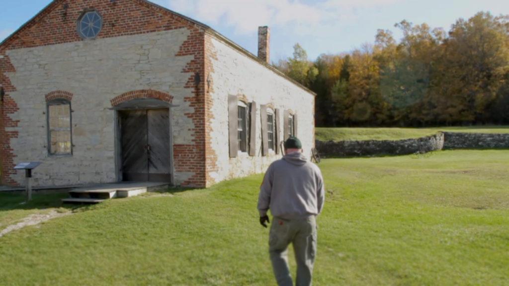 man in Fayette historic townsite walking towards a building