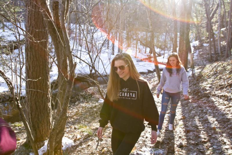 2 teenage girls hiking in the woods