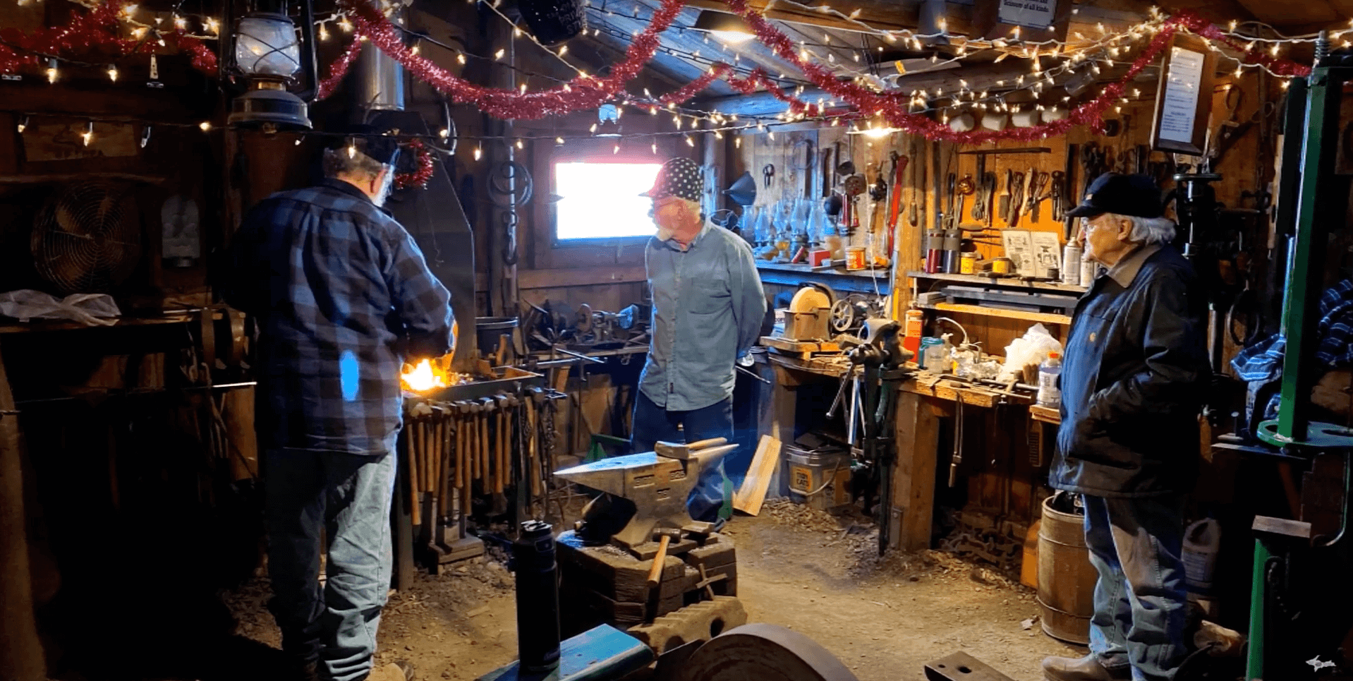 three people looking at the blacksmith display in Escanaba