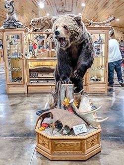 Taxidermized bear standing in entrance of Rapid River Knifeworks