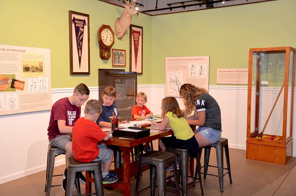 Children sitting at table working on interactive lesson at Webster Marble Museum.