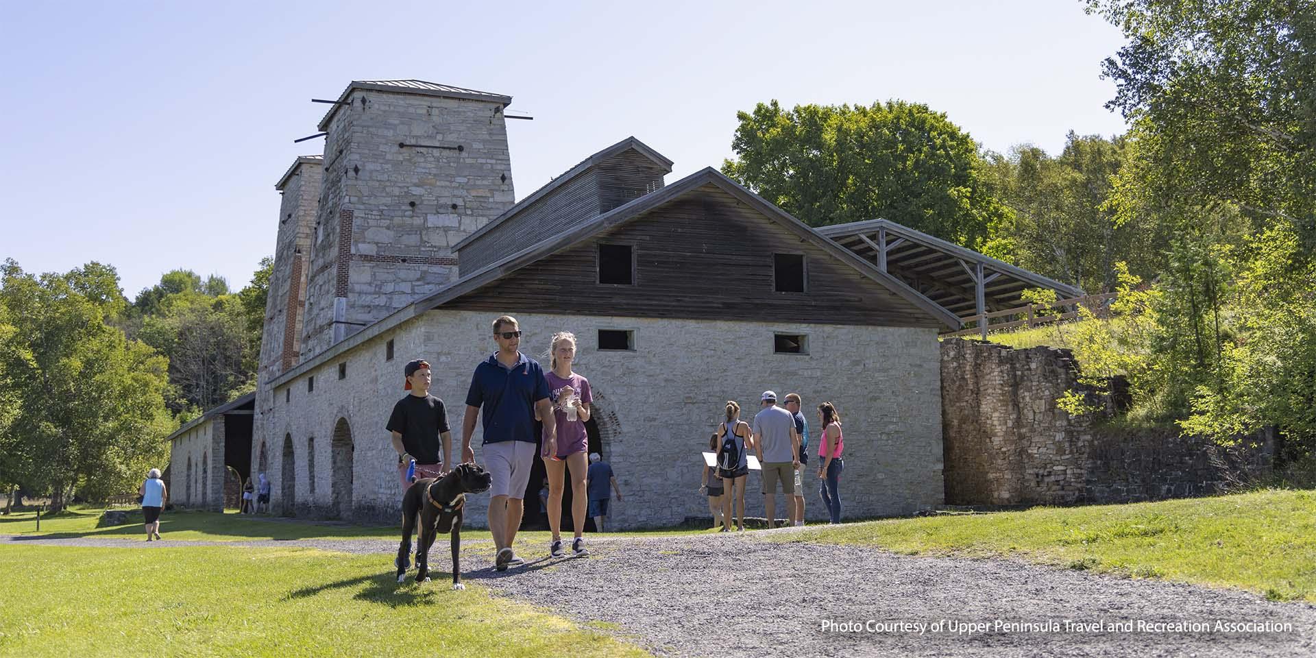 Visitors walking a dog at Fayette Historic State Park