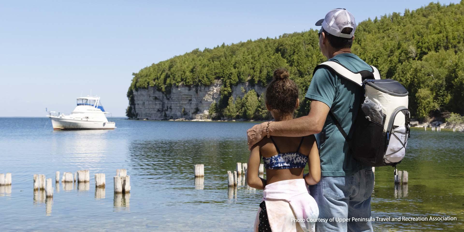 Grandfather and grandchild looking out into the bay